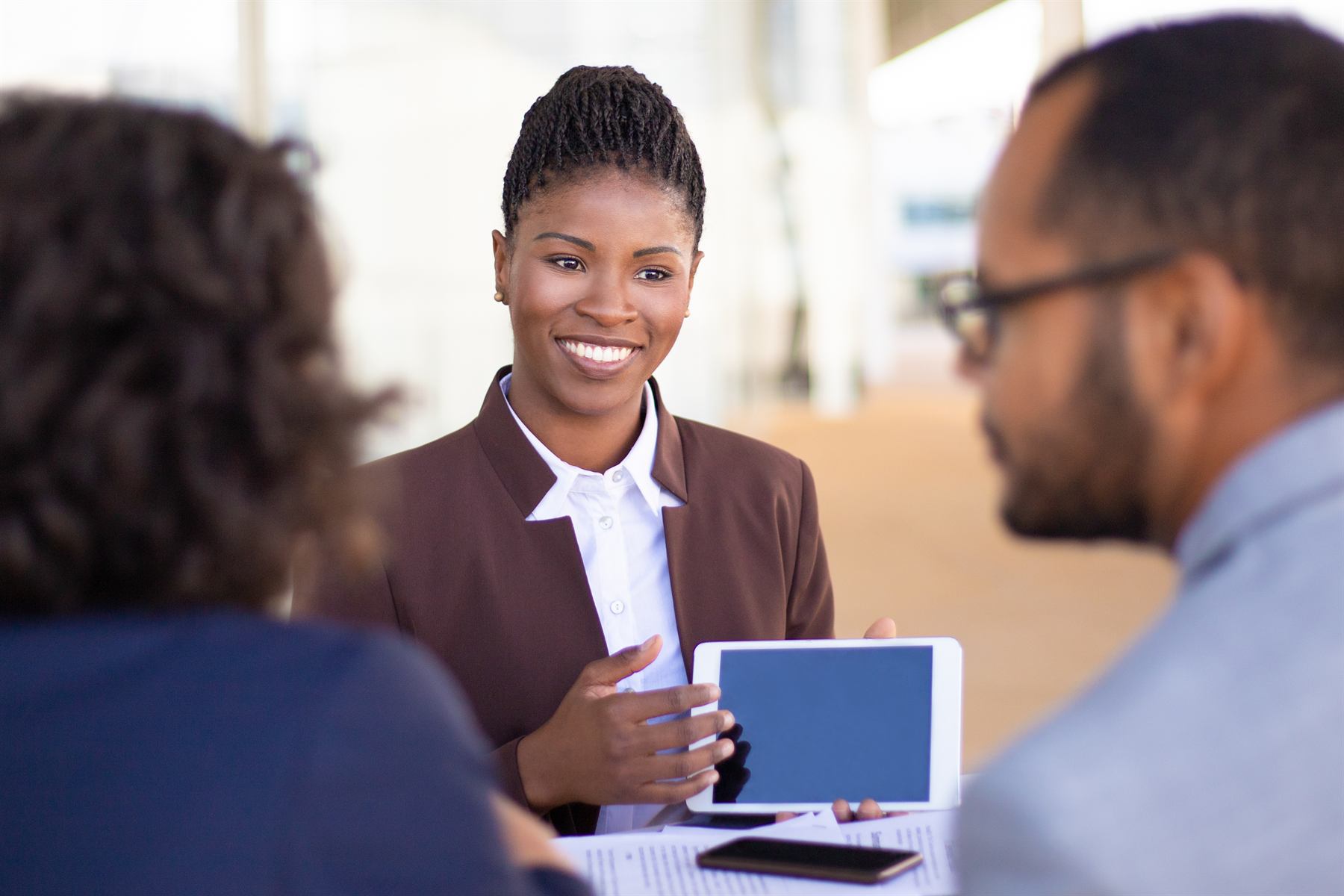 An Apex consultant walking two clients through candidate profiles on a tablet